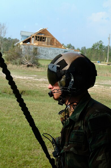 Tech. Sgt. Keith Berry, an Air Force Reserve Command pararescueman from the 304th Rescue Squadron in Portland, Ore., checks for overhanging tree limbs near his HH-60 Pave Hawk helicopter as it returns to the skies over southern Mississippi after checking on Hurricane Katrina survivors. Air Force photo by Master Sgt. Bill Huntington