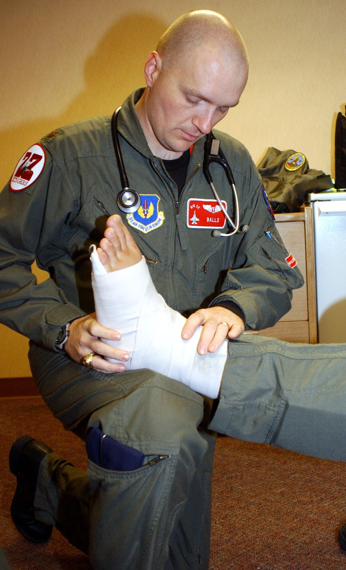 EIELSON AIR FORCE BASE, Alaska -- Maj. (Dr.) David Cotton, the Cope Thunder 6-01 flight surgeon, examines a patient's ankle. The doctor is on temporary duty here from 52nd Medical Group from Spangdahlem Air Base, Germany. The two-week Alaskan exercise, Pacific Air Forces' largest air combat training exercise, involves more than 1,000 active-duty and Air National Guard Airmen and 87 aircraft. (Air Force photo by Staff Sgt. A.C. Eggman)