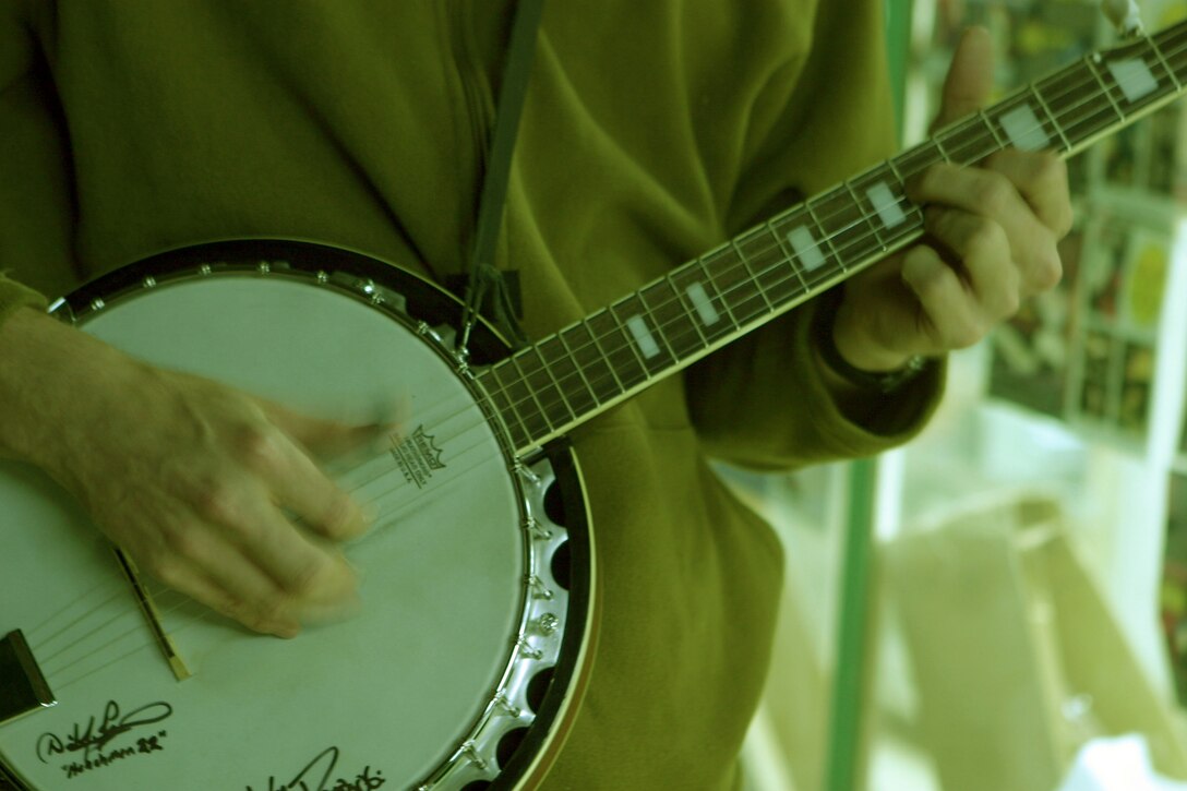 CAMP TAQADDUM, Iraq (Oct. 20, 2005) ? Lance Cpl. Bradford E. Laws ?rocks out? on his banjo here Oct. 20. This Marine?s six years of playing the banjo in the United States was not put on hold for his deployment here. Laws is a nuclear, biological and chemical specialist with Headquarters Company, Headquarters and Service Battalion and 2nd Force Service Support Group (Forward).