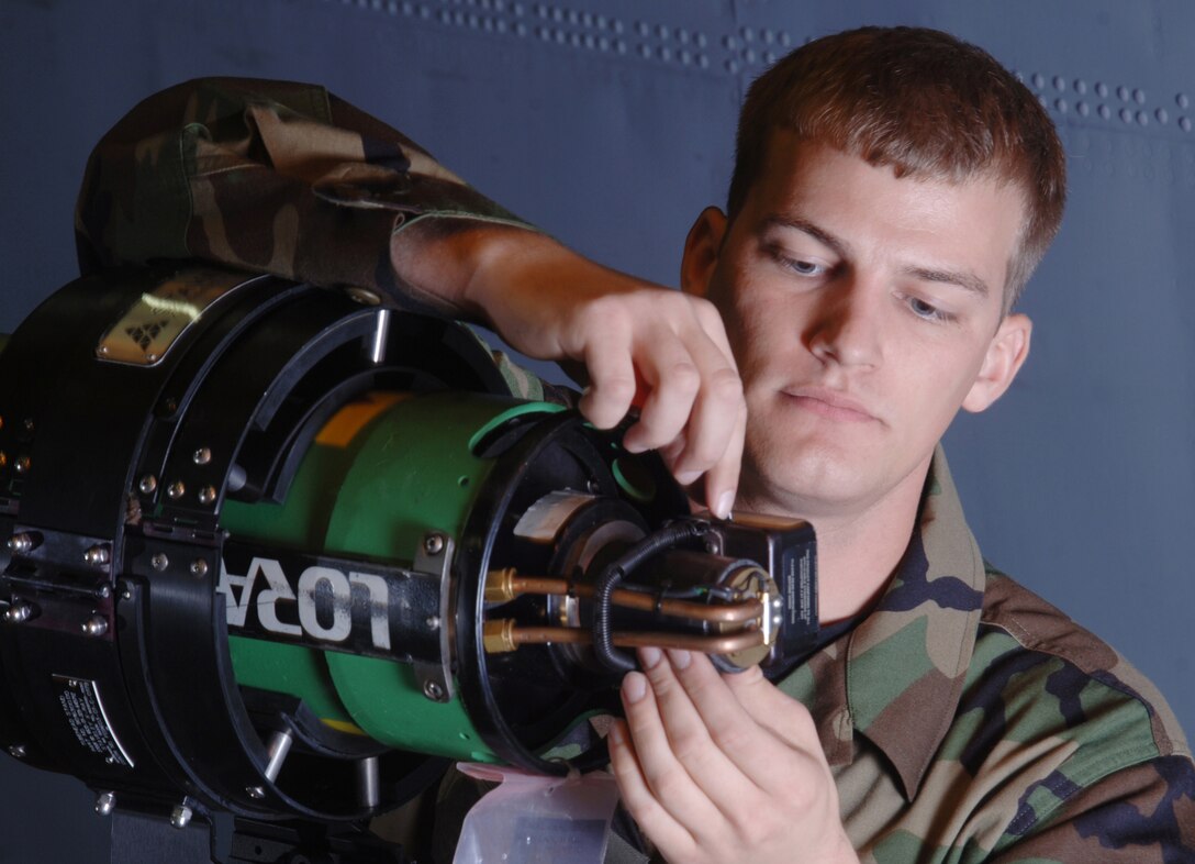 YOKOTA AIR BASE, Japan -- Senior Airman Jonathan Keller prepares to operate a Lorad portable X-ray equipment during inspection of a C-130 Hercules aircraft inside a hangar here. The nondestructive inspection technician, assigned to the 374th Maintenance Squadron here, is checking the door frame of the aircraft for structural cracks. NDI Airmen use X-ray and advanced technology to examine the uniformity, quality and serviceability of components of assigned and in-transit aircraft.  (U.S. Air Force photo by Master Sgt. Val Gempis)