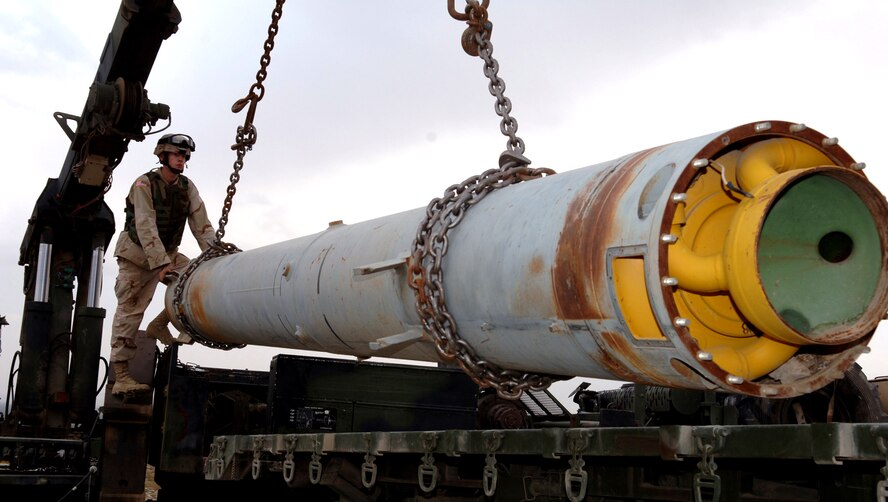 BAGRAM FIELD, Afghanistan -- Army Sgt. Thomas Kio guides the loading of one of three 5,000-pound rockets onto a wrecker truck. Germany-based Soldiers joined members of the 455th Expeditionary Civil Engineer Squadron Explosive Ordnance Disposal Flight here in transporting the rockets from an old Soviet ammunition supply dump near here to a secure site for destruction. The Soldier is from 23rd Ordnance Company at Miesau, Germany. (U.S. Air Force photo by Staff Sgt. Marcus McDonald)
