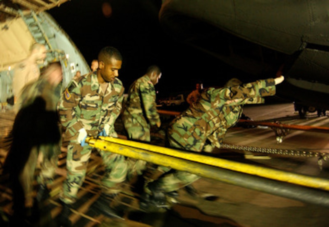 Soldiers from the U.S. Army's 1st Cavalry of Fort Hood, Texas, off-load a CH-47 Chinook helicopter from an Air Force C-5 Galaxy aircraft in Rota, Spain, on Oct. 16, 2005. The Department of Defense is participating in the multinational effort to provide humanitarian assistance and support to Pakistan and parts of India and Afghanistan following a devastating earthquake. 