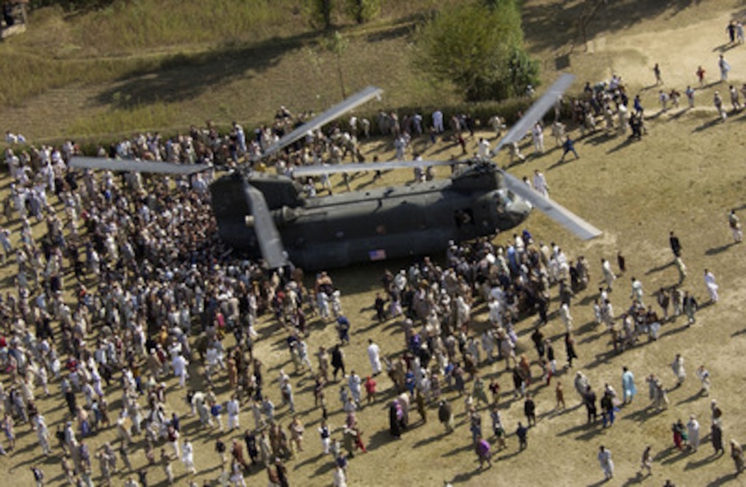 Pakistani earthquake victims crowd around a U.S. Army CH-47 Chinook helicopter delivering disaster relief supplies to the earthquake devastated area surrounding the town of Oghi, Pakistan, on Oct. 17, 2005. The Department of Defense is participating in the multinational effort to provide humanitarian assistance and support to Pakistan and parts of India and Afghanistan following a devastating earthquake. 