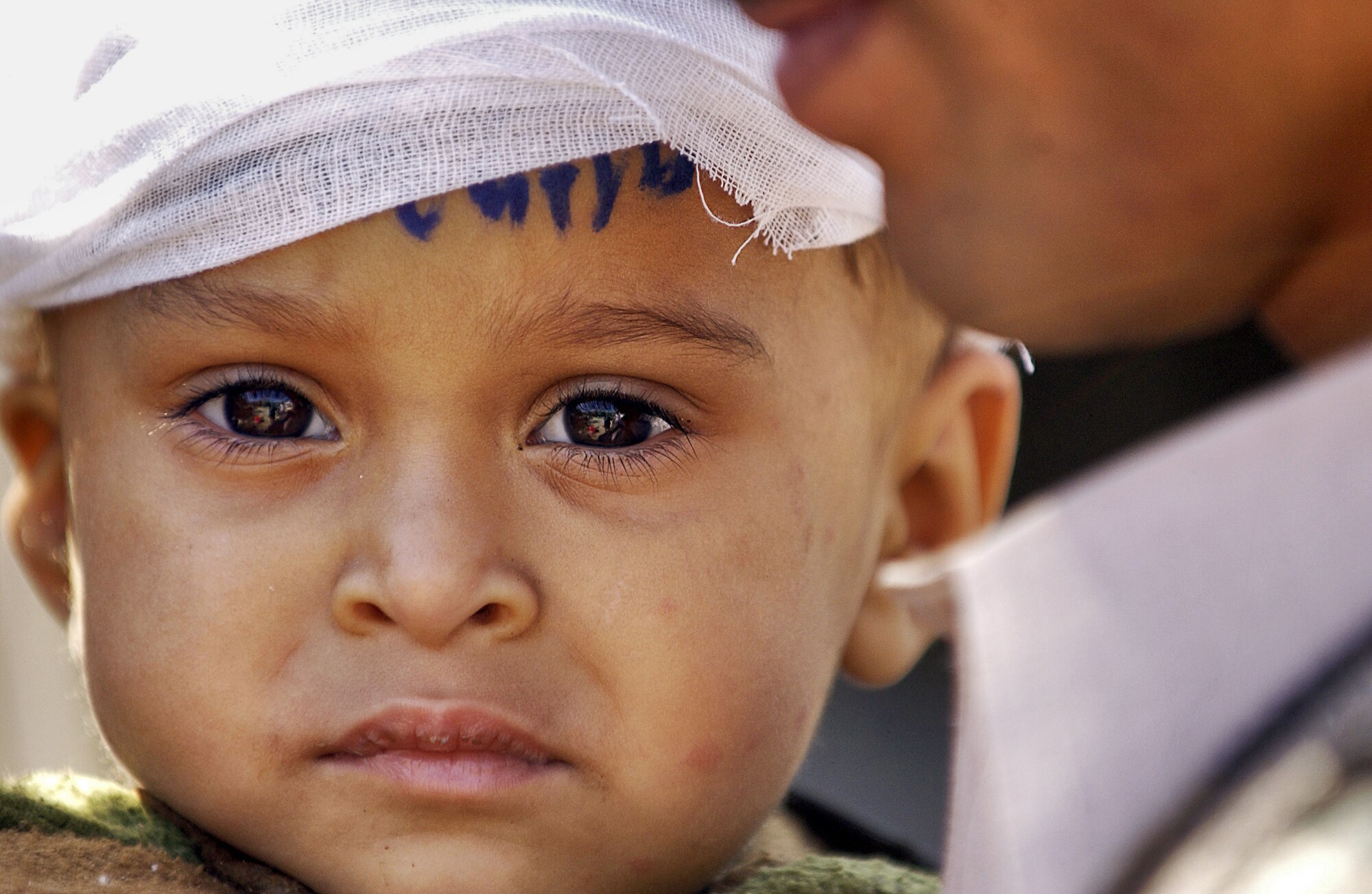 MUZAFFARABAD, Pakistan -- An injured Pakistani child here waits for transport to a medical center in Islamabad Oct. 20. U.S. servicemembers are participating in a huge multinational humanitarian aid and support in areas of the country devastated by an Oct. 8 earthquake. Pakistani officials announced the quake has killed more than 48,000 and left millions homeless. (U.S. Air Force photo by Tech. Sgt. Jeromy K. Cross) 