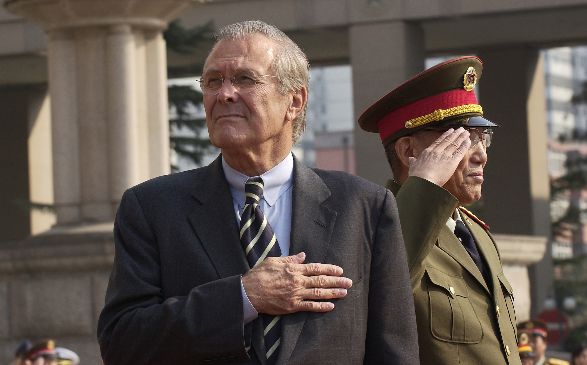 BEIJING -- Secretary of Defense Donald H. Rumsfeld and Gen. Cao Gangchuan, vice chairman of the central military committee, and China's minister of defense, show their respect during the playing of their countries' national anthems at the Bayi Building here. Secretary Rumsfeld traveled to China Oct. 19 to meet with military and civilian leaders and discuss U.S.-China defense relationships and cooperation in areas of common interest. (U.S. Air Force photo by Master Sgt. James M. Bowman)

