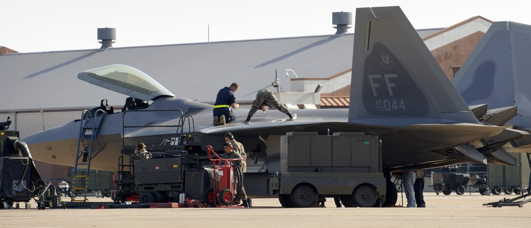 LANGLEY AIR FORCE BASE, Va. -- Airmen with the 27th Aircraft Maintenance Unit make final inspection checks on an F/A-22 Raptor before launching it. The Raptor was bound for Hill Air Force Base, Utah. The unit deployed there Oct. 15 with a twofold goal: complete a deployment and to generate a combat-effective sortie rate away while deployed. (U.S. Air Force photo by Staff Sgt. Eric T. Sheler)