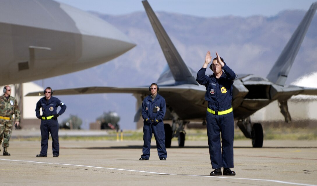 HILL AIR FORCE BASE, Utah -- Crew chief Senior Airman Alexander launches an F/A-22 Raptor for a Combat Hammer mission here. The maintainer deployed from Langley Air Force Base, Va., with the 27th Aircraft Maintenance Unit to support the 27th Fighter Squadron during its first-ever deployment. The deployment has a twofold goal: complete a deployment and to generate a combat-effective sortie rate away while deployed. (U.S. Air Force photo by Tech. Sgt. Ben Bloker) 