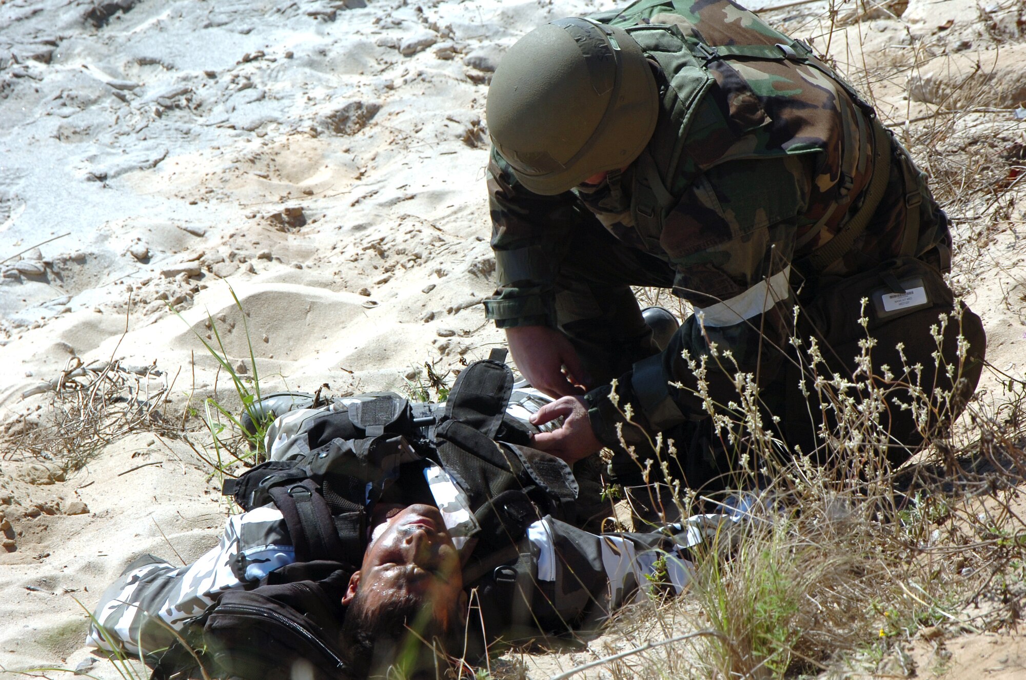 EGLIN AIR FORCE BASE, Fla. -- Senior Airman David Kerr secures a "captured" Staff Sgt. Jason Libman. The sergeant was an "opposing force" member that took part in a mock attack -- part of an operational readiness inspection -- on a 728th Air Control Squadron deployed radar site here. (U.S. Air Force photo by Capt. Kristi Beckman)