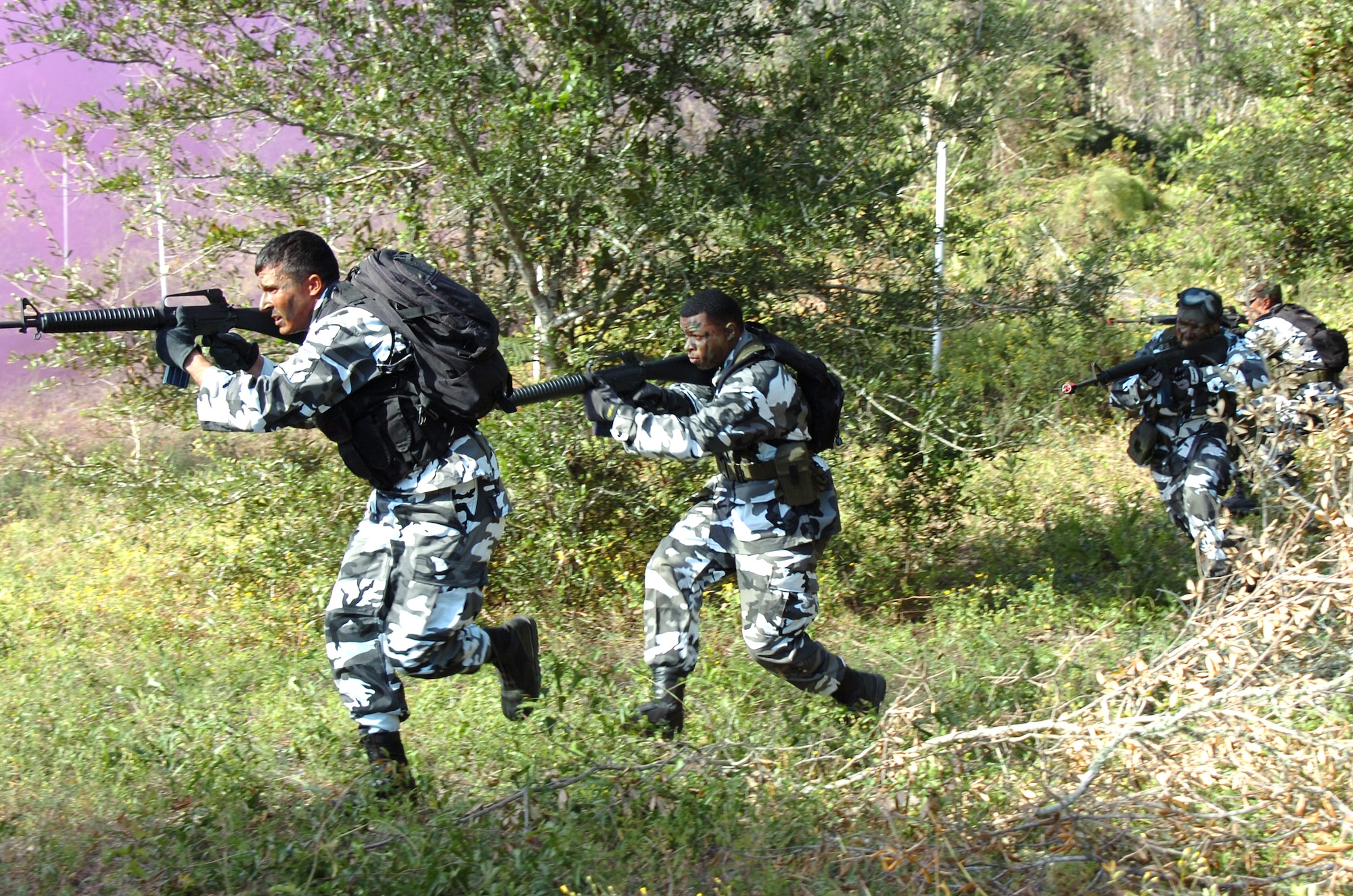 EGLIN AIR FORCE BASE, Fla. -- Staff Sgt. Jason Libman and Senior Airman Renaldo Miller lead an "opposing forces" attack on a defensive fighting position during an exercise here. The mock attack -- part of an operational readiness inspection -- was on a 728th Air Control Squadron deployed radar site. (U.S. Air Force photo by 1st Lt. David Tomiyama)