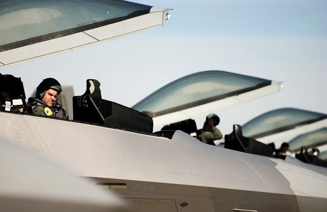 HILL AIR FORCE BASE, Utah -- Capt. Jeoff Lohmiller prepares to fly the first F/A-22 Raptor aerial mission of the Combat Hammer exercise here Oct. 17. The captain is with the 27th Fighter Squadron at Langley Air Force Base, Va. The squadron came here on its first deployment, Oct. 15. The deployment has a twofold goal: complete a deployment and to generate a combat-effective sortie rate away while deployed. (U.S. Air Force photo by Tech. Sgt. Ben Bloker) 