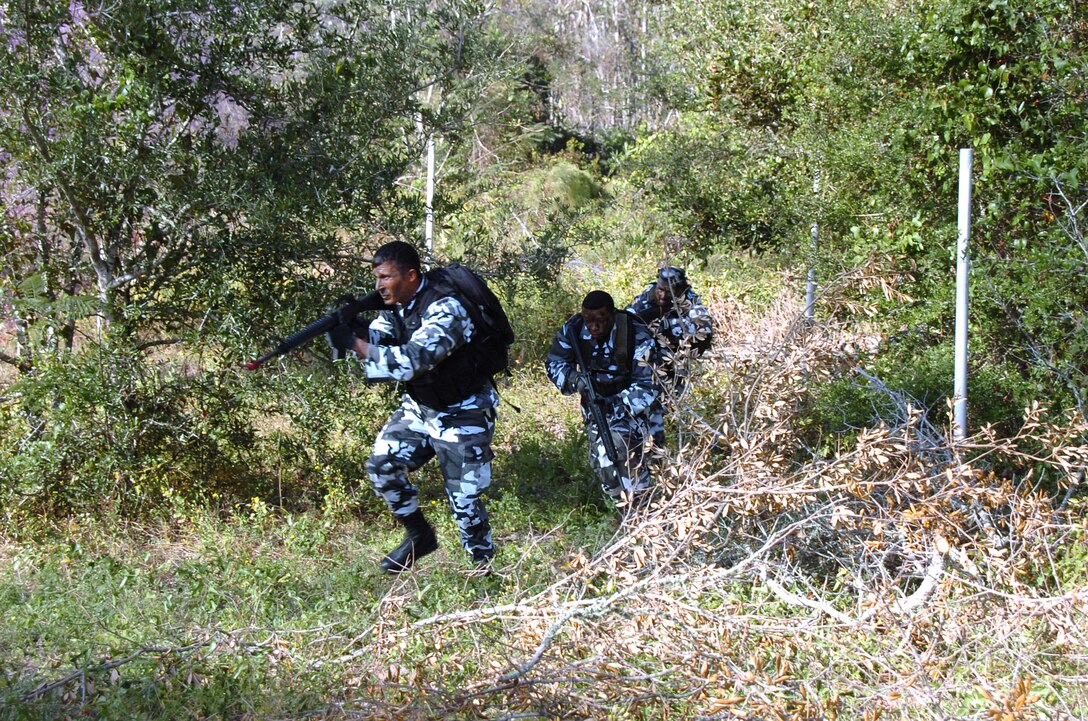 EGLIN AIR FORCE BASE, Fla. -- Staff Sgt. Jason Libman and Senior Airman Renaldo Miller lead an "opposing forces" attack on a defensive fighting position during an exercise here. The mock attack -- part of an operational readiness inspection -- was on a 728th Air Control Squadron deployed radar site. (U.S. Air Force photo by 1st Lt. David Tomiyama)