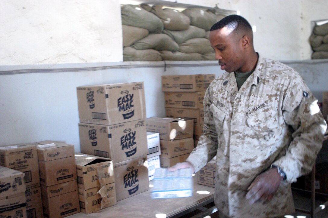 Master Sgt. Elvis S. Dixon prepares his stock for sale here Oct. 23. The small group of exchange Marinestravels from Camp Taqaddum, Iraq, to various forward operating bases to bring a small piece of comfort to service members who don?t have the luxury of an immediate post exchange at their location. Dixon is the operations chief for the Camp Taqaddum post exchange.