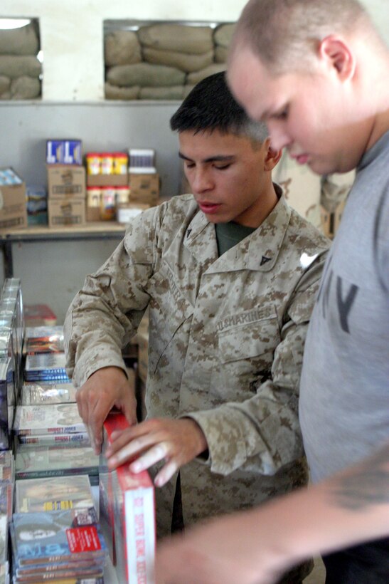Lance Cpl. Juan J. Rivera prepares his stacks boxes of food here Oct. 23. The small group of exchange Marinestravels from Camp Taqaddum, Iraq, to various forward operating bases to bring a small piece of comfort to service members who don?t have the luxury of an immediate post exchange at their location. Rivera is an exchange Marine with 2nd Force Service Support Group (Forward).