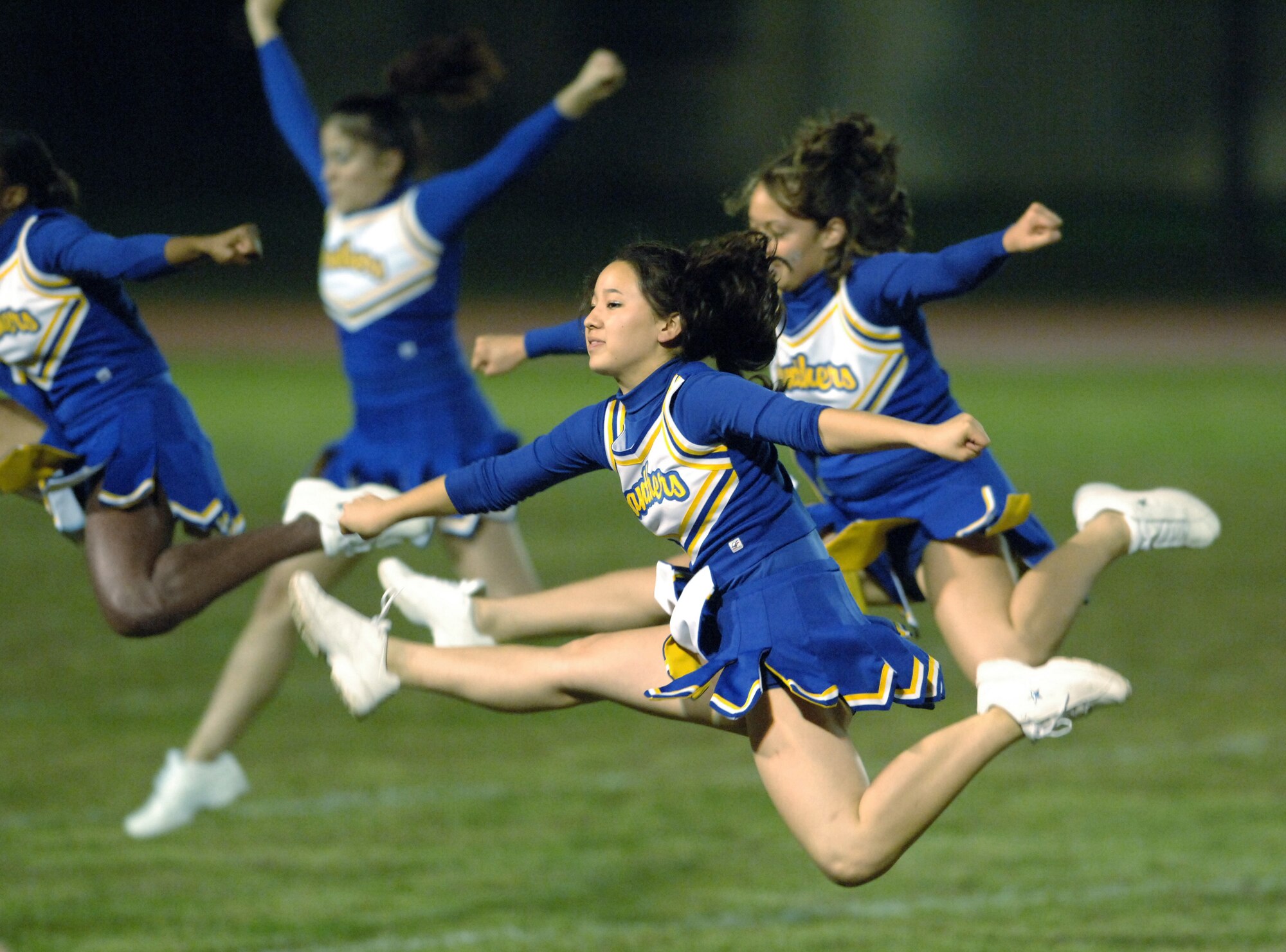 YOKOTA AIR BASE, Japan (AFPN) -- Jennifer Higuchi, foreground, and her teammates from Yokota High School cheer during half time of the Panther's "homecoming" football game here. The Panthers beat Edgren High School from Misawa Air Base, Japan, 52-0. (U.S. Air Force photo by Master Sgt. Val Gempis)