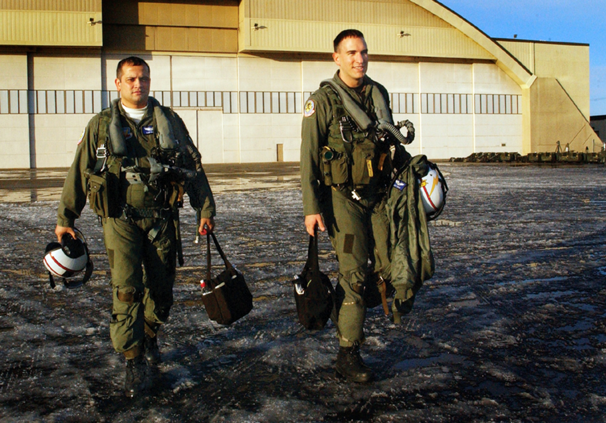 EIELSON AIR FORCE BASE, Alaska -- Electronic counter-measure officers Capt. Sam Hilyer (left) and 1st Lt  Matt Polus walk from the "Thunderdome" hangar after flying a Cope Thunder 06-1 mission. The military exchange pilots fly with Electronic Attack Squadron 133 at Naval Air Station Whidby Island, Wash. Cope Thunder, a two-week air and ground combat exercise involving more than 1,000 Airmen and Sailors and 87 aircraft that started Oct. 7, ended Oct. 20. (U.S. Air Force photo by Tech. Sgt. Scott Farrow) 