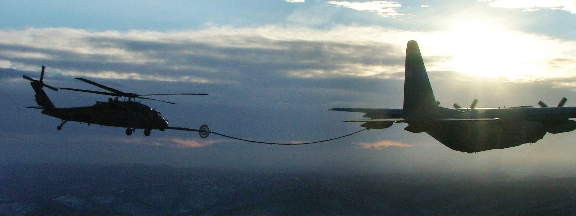 EIELSON AIR FORCE BASE, Alaska -- A HH-60 Pave Hawk refuel from a C-130 Hercules tanker after a simulated combat search and rescue mission over the Pacific Alaskan Range Complex during the Cope Thunder exercise. Cope Thunder, a two-week air and ground combat exercise involving more than 1,000 Airmen and Sailors and 87 aircraft that started Oct. 7, ended Oct. 20. (U.S. Air Force photo by 1st Lt. Gregory Price)