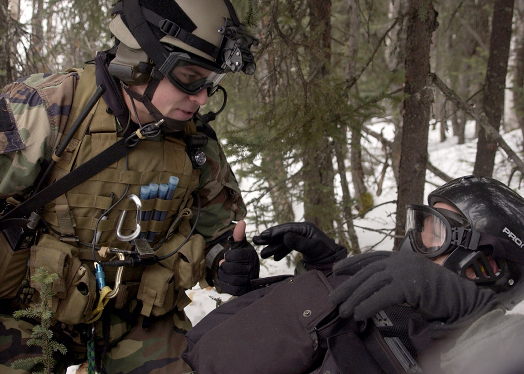 EIELSON AIR FORCE BASE, Alaska -- A pararescueman communicates with a rescued pilot during a combat search and rescue training mission during the Cope Thunder 06-01. The "PJ" is with the 320th Special Tactics Squadron at Kadena Air Base, Japan. Cope Thunder, a two-week air and ground combat exercise involving more than 1,000 Airmen and Sailors and 87 aircraft that started Oct. 7, ended Oct. 20. (Air Force photo by Airman 1st Class Rachel Walters) 