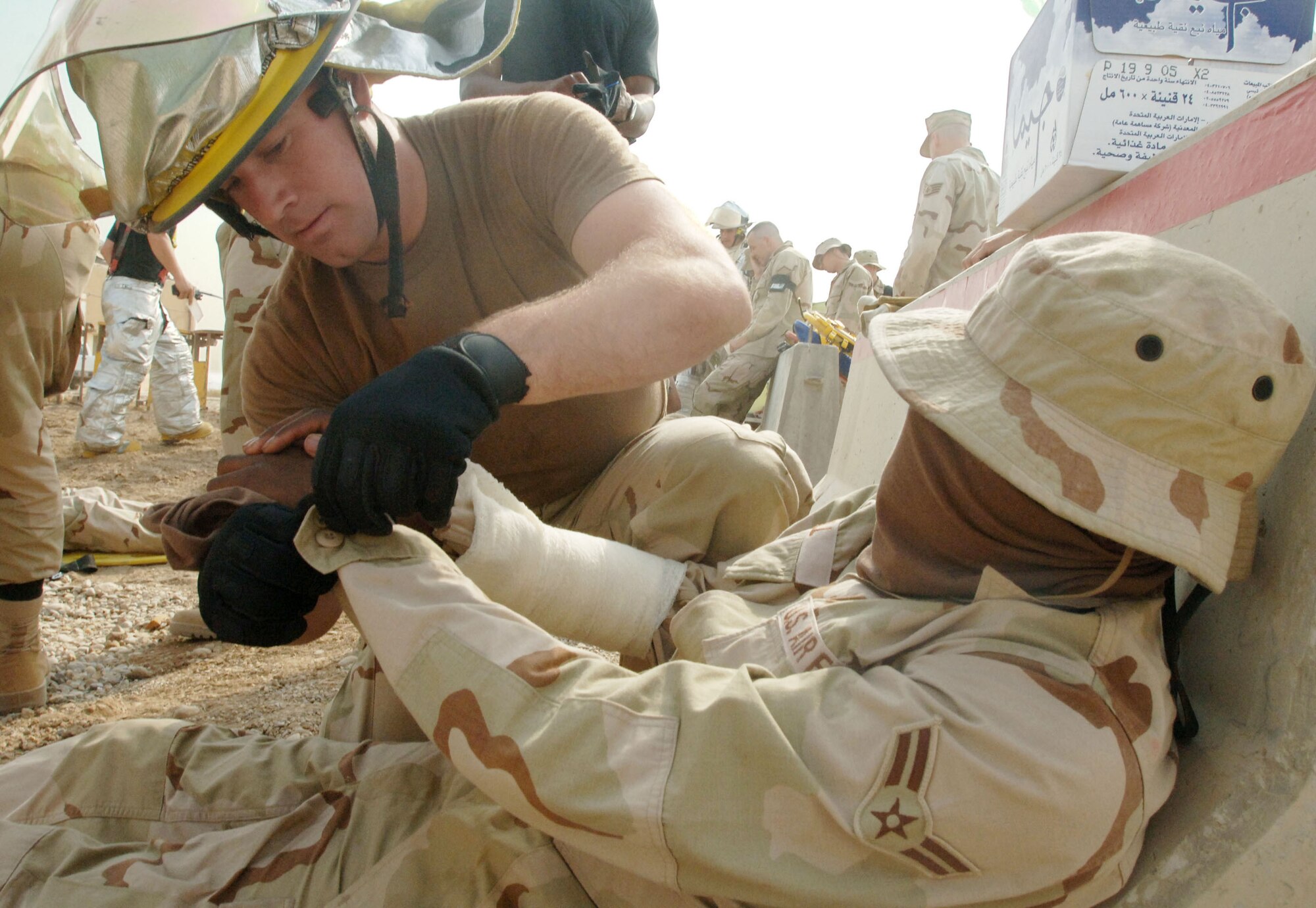 ALI BASE, Iraq -- Firefighter Airman 1st Class Robert Nicks provides care to an "injured Airman" during a mass casualty fire alert exercise here. The 407th Expeditionary Civil Engineer Squadron fire department held the exercise to prepare base firefighters for real world events. The Airman deployed here from the 60th Civil Engineers Squadron at Travis Air Force Base, Calif. (U.S. Air Force photo by Senior Airman Jennifer Haas) 