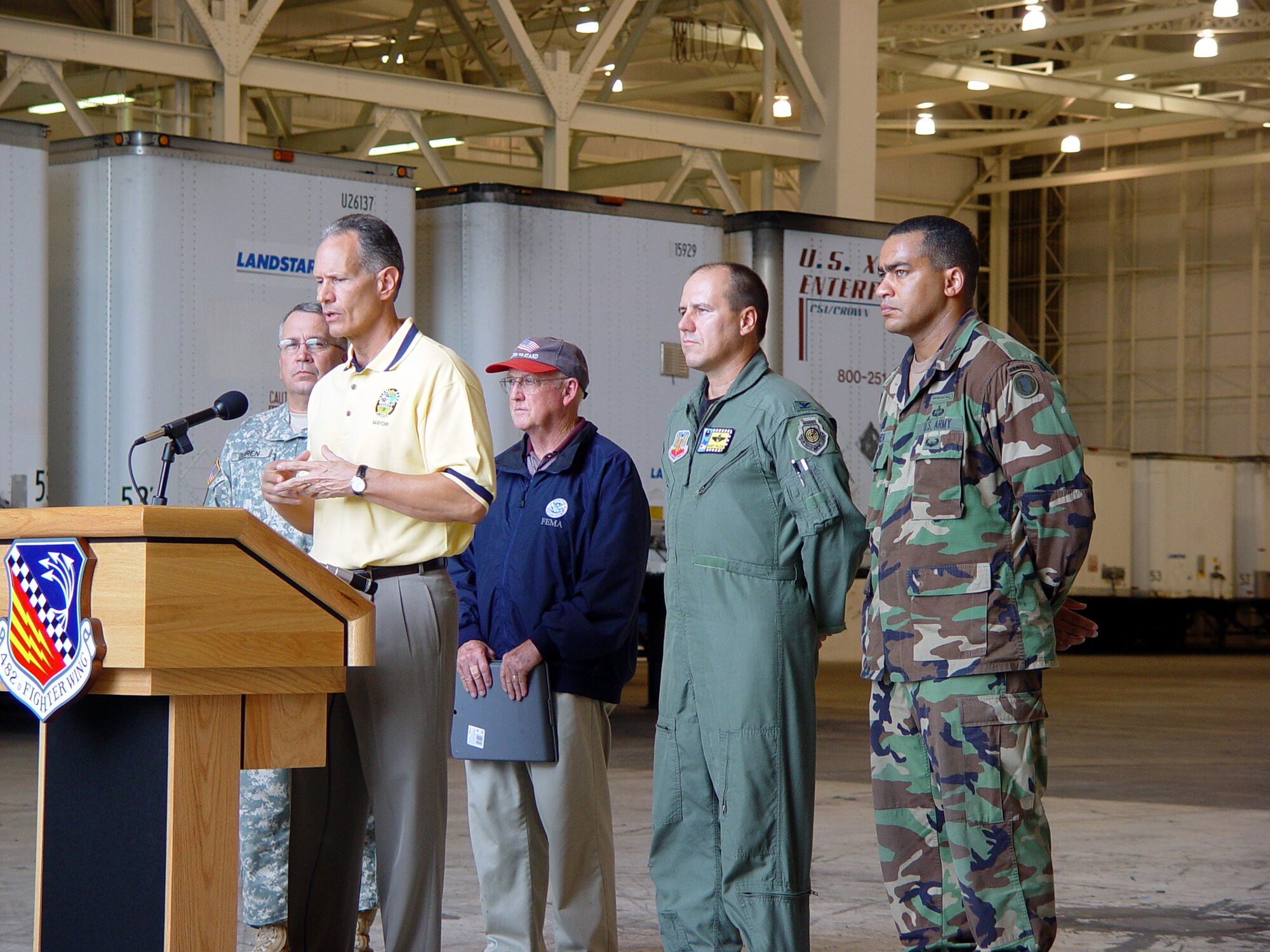 Officials host a joint press conference at Homestead Air Reserve Base, Fla. to inform local citizens about preparations for Hurricane Wilma.  The Federal Emergency Management Agency has partnered with Homestead Air Reserve Base to set up a relief staging area that will be used post-strike if necessary.  Picutred right to left:  Army Maj. Angel Mesa, 87th Brigade, Patrick AFB, Fla., Col. Randy Falcon, commander, 482d Fighter Wing, Homestead ARB, Fla., Mr. Frank Huff, FEMA's site coordinator at Homestead ARB, Fla., and Army Col. Joseph Duren, commander of the 50th Area Support Group, Florida Army National Guard.  Speaking at the podium is the Mayor of Miami-Dade County, Carlos Alvarez.