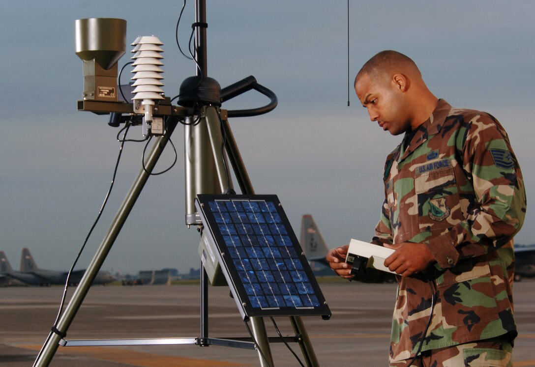 YOKOTA AIR BASE, Japan -- Tech. Sgt. Damion Madison sets up a tactical meteorological observation system during training at the flightline here. The system is a collection of weather sensors connected to a computer and Iridium data modem that measure cloud base, surface pressure, temperatures, dew points, wind speed and density altitude. It provides near-real-time mission-critical weather date to war planners and decision makers. The sergeant is a member of the 374th Operations Support Squadron combat weather team here. (U.S. Air Force photo by: Master Sgt. Val Gempis)