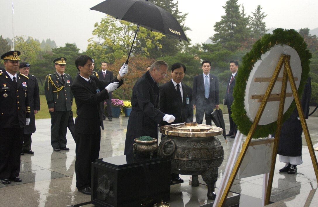 SEOUL, South Korea -- Secretary of Defense Donald H. Rumsfeld takes part in a wreath laying ceremony at the National Cemetery here. The secretary was here Oct. 21, to meet to meet with South Korean Minister of National Defense Yoon Kwang-ung. Secretary Rumsfeld also conducted the 37th United States and Republic of Korea Security Consultative Meeting to discuss defense policy issues and the future of the two nations' alliance.  (U.S. Air Force photo by Master Sgt. James M. Bowman)