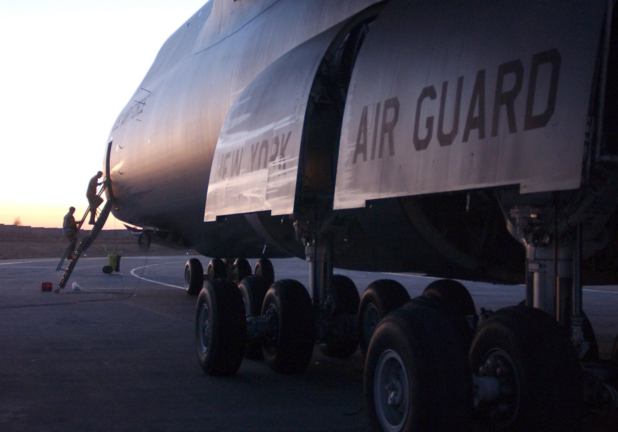 MANAS AIR BASE, Kyrgyzstan -- Airmen board a C-5 Galaxy at sunset here. The giant transport, from the 105th Airlift Wing of the New York Air National Guard arrived here Oct. 21 full of cargo to support Operation Enduring Freedom and relief efforts in Pakistan. (U.S. Air Force photo by Airman 1st Class Dayton Mitchell)