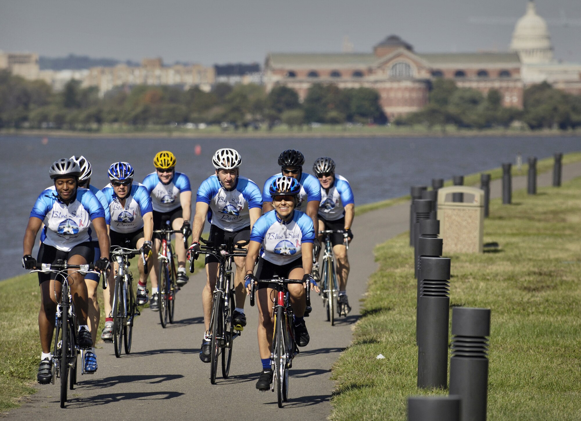 BOLLING AIR FORCE BASE, D.C. -- Gloria Padilla, a human resources specialist for the 11th Wing here, leads a pack of Blue Suit Pacers teammates on a training ride around this historic base. The group -- riding here Oct. 19 -- has about 30 Airmen and other government workers from the D.C. area. They get together to enjoy riding their bicycles and raise money for worthy causes. Most recently the group raised more than $1000 for hurricane Katrina victims.  (U.S. Air Force photo by Master Sgt. Jim Varhegyi)