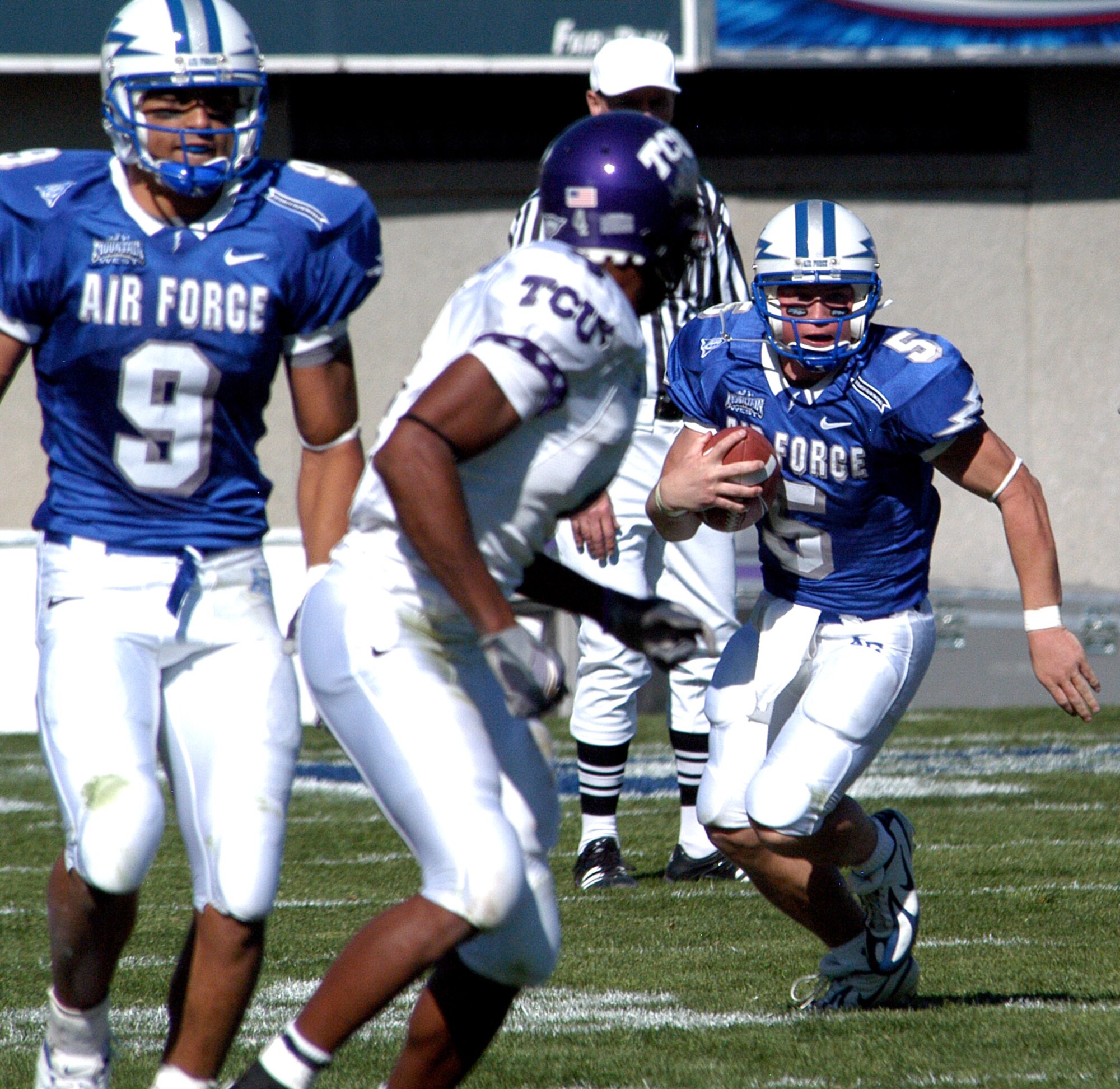 U.S. AIR FORCE ACADEMY, Colo. -- Falcons quarterback Shaun Carney weaves his way through Texas Christian University defenders for extra yardage. TCU won, 48-10, Oct. 22.  (U.S. Air Force photo by 2nd Lt. John Ross)