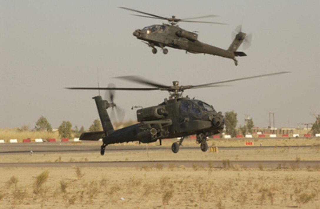 Two U.S. Army AH-64D Longbow Apache helicopters return from a combat mission to Forward Operating Base Speicher, Iraq, on Oct. 22, 2005. The Apaches are attached to the 1st Battalion, 101st Aviation Regiment, Fort Campbell, Ky. 