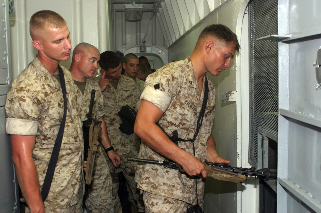 Cpl. Harry A. Stewart, of Asheville, N.C., a mortar man with the 81mm mortar platoon of Battalion Landing Team 1st Bn., 6th Marines, turns in weapon into the armory aboard the USS NASSAU, Sept. 22, 2005.  BLT 1/6 is the ground combat element of the 22nd Marine Expeditionary Unit, which is scheduled to deploy later this year.