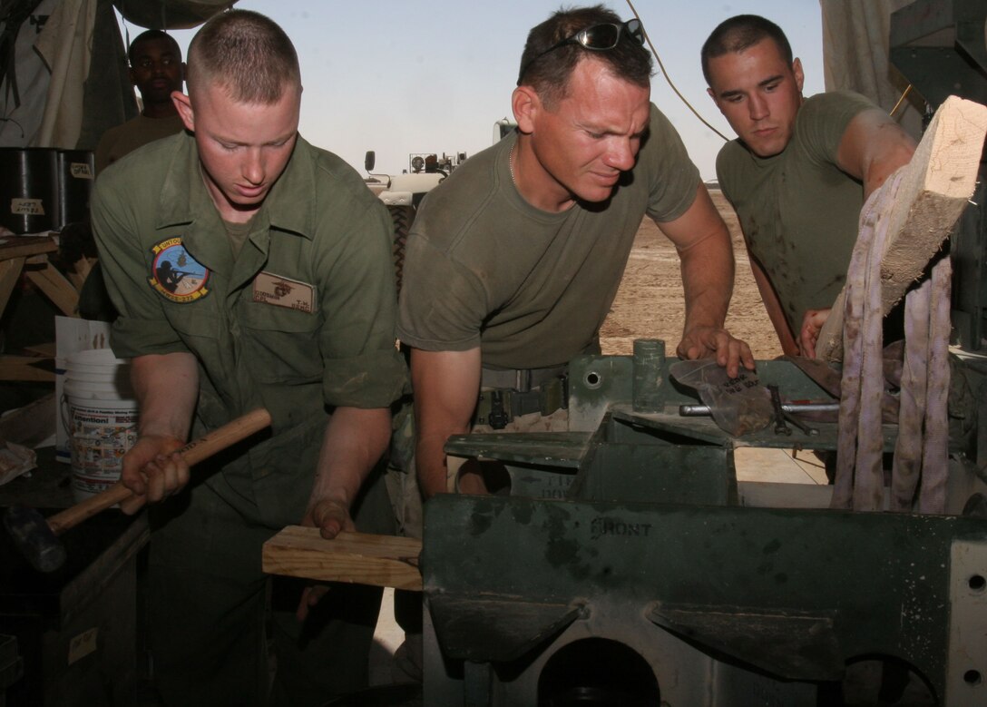 Cpl. Travis Goodwin and Staff Sgt. James Seeger, members of Marine Wing Support Squadron 272?s expeditionary airfield team, inspect a part from a recently dismantled M31 arrested landing gear system.  The team performed biannual preventative maintenance on the part to ensure optimal equipment readiness.