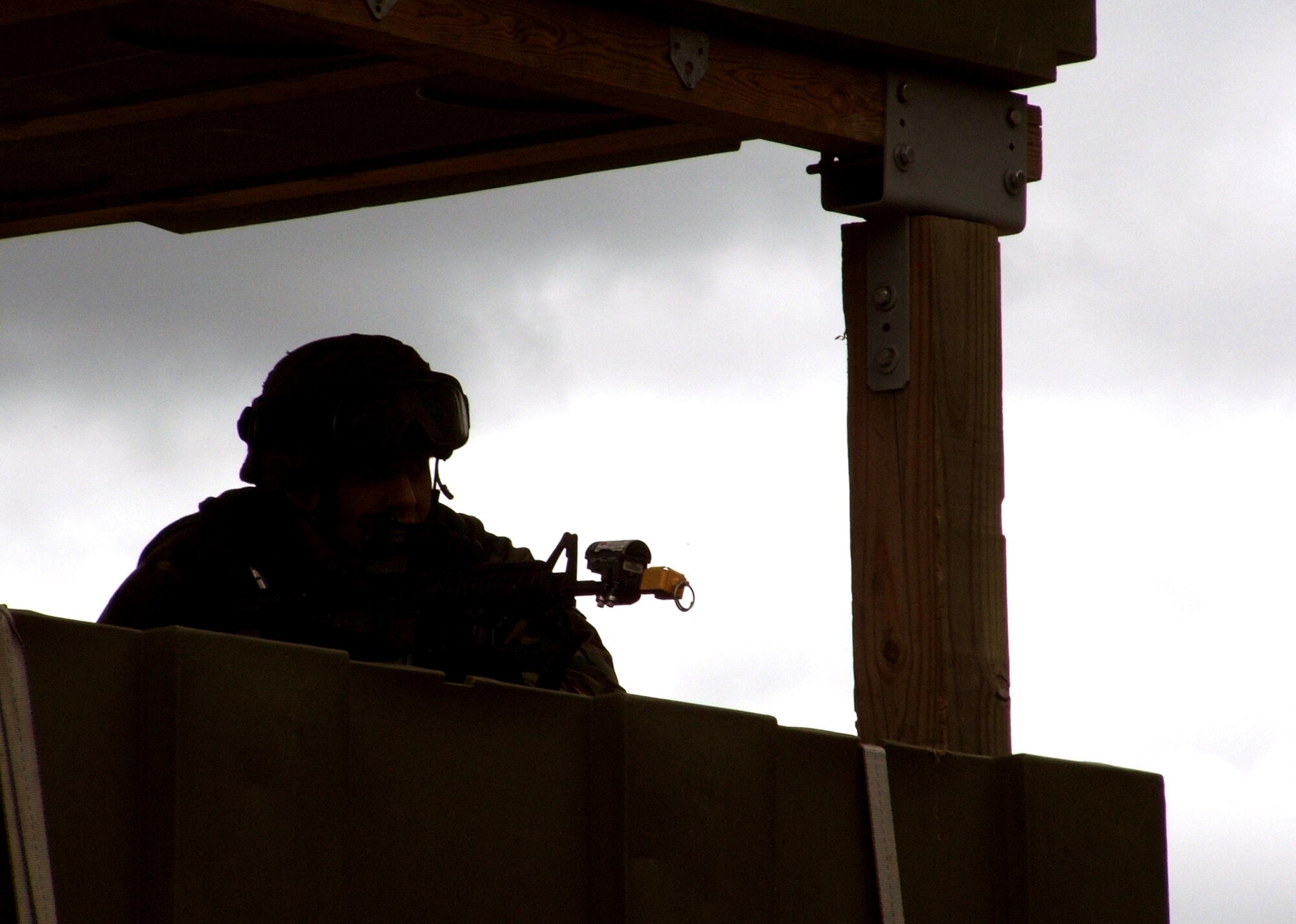 NAVAL AIR ENGINEERING STATION, LAKEHURST, N.J. (AFPN) -- An Air Force security forces troop keeps watch for intruders from a guard tower here. The Airman was on duty Oct. 24 during exercise Eagle Flag. He deployed here from the 613th Security Forces Squadron at Anderson Air Force Base, Guam, to support the 613th Contingency Response Group. (U.S. Air Force photo by Tech. Sgt. Scott T. Sturkol)