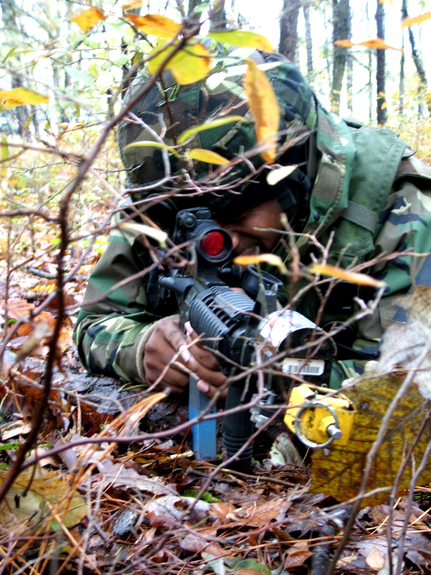 NAVAL AIR ENGINEERING STATION LAKEHURST, N.J. (AFPN) -- Staff Sgt. Ricky Faulk takes cover in the wood while on patrol near here. The Airman, on patrol here Oct. 22., deployed from the 613th Security Forces Squadron, Andersen Air Force Base, Guam, to take part in exercise Eagle Flag 06-1, which began Oct. 21. (U.S. Air Force photo by Tech. Sgt. Scott T. Sturkol)