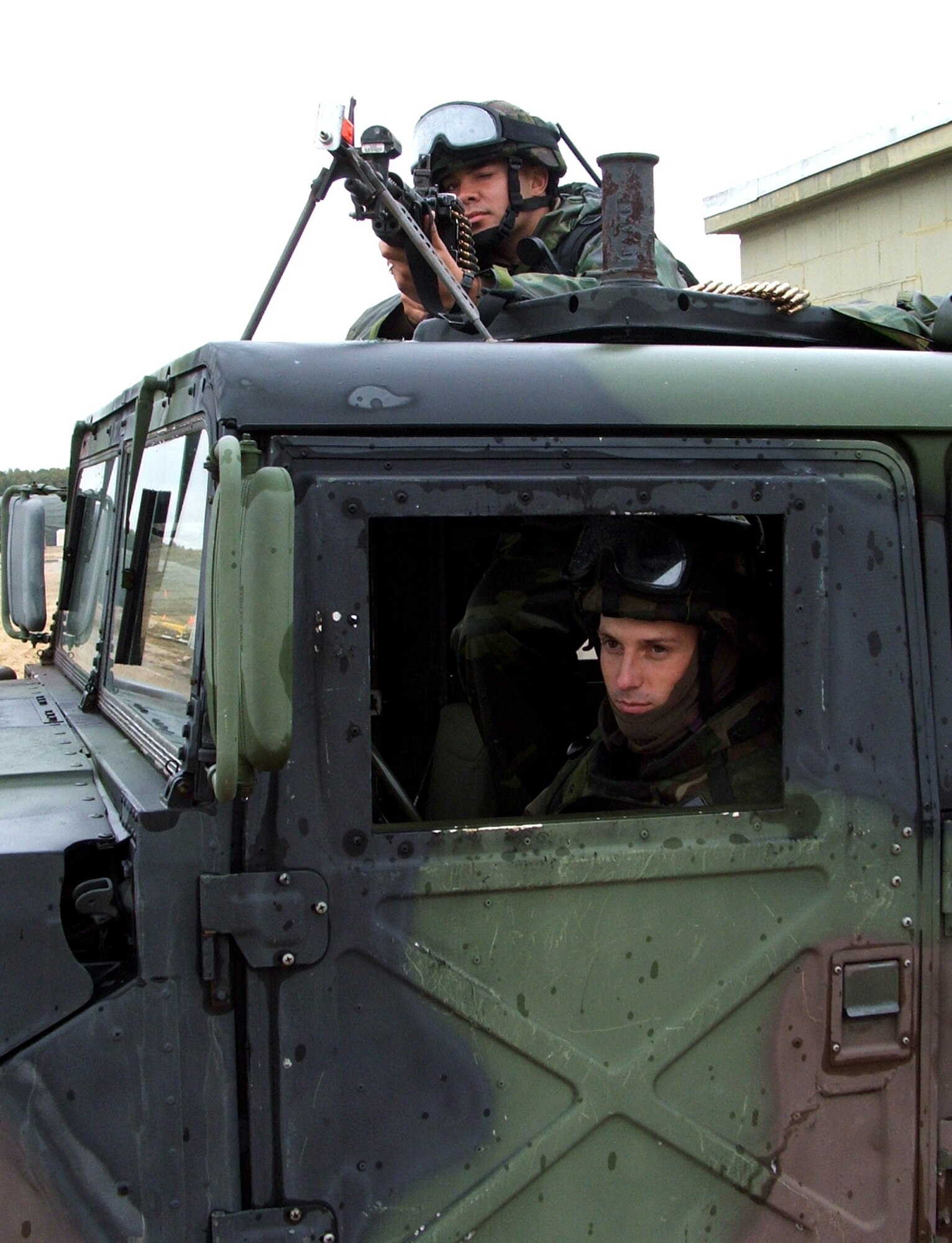 NAVAL AIR ENGINEERING STATION LAKEHURST, N.J. (AFPN) -- Senior Airmen Jeff Bury (top) and William Glidewell guard an entry control point to an Air Force camp here. The Airmen and others are taking part in exercise Eagle Flag 06-1, which began Oct. 21. The troops, from the 613th Security Forces Squadron at Anderson Air Base, Guam, deployed to support the 613th Contingency Response Group.  (U.S. Air Force Photo by Tech. Sgt. Scott T. Sturkol)Response Group which was the first unit to deploy into Eagle Flag.  (U.S. Air Force photo by Tech. Sgt. Scott T. Sturkol)