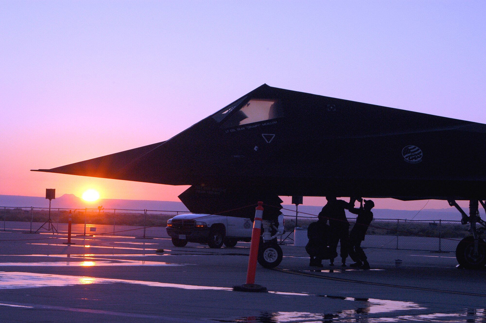 EDWARDS AIR FORCE BASE, Calif. -- Maintainers do an early morning check on an F-117 Nighthawk here. The Airmen, from the 410th Flight Test Squadron at Plant 42 in Palmdale, Calif., did their work Oct. 23. The stealth fighter was on static display Oct. 22 and 23 at the 2005 Edwards Open House and Air Show. About 120,000 people attended the event. (U.S. Air Force photo by Tech. Sgt. Eric Grill)