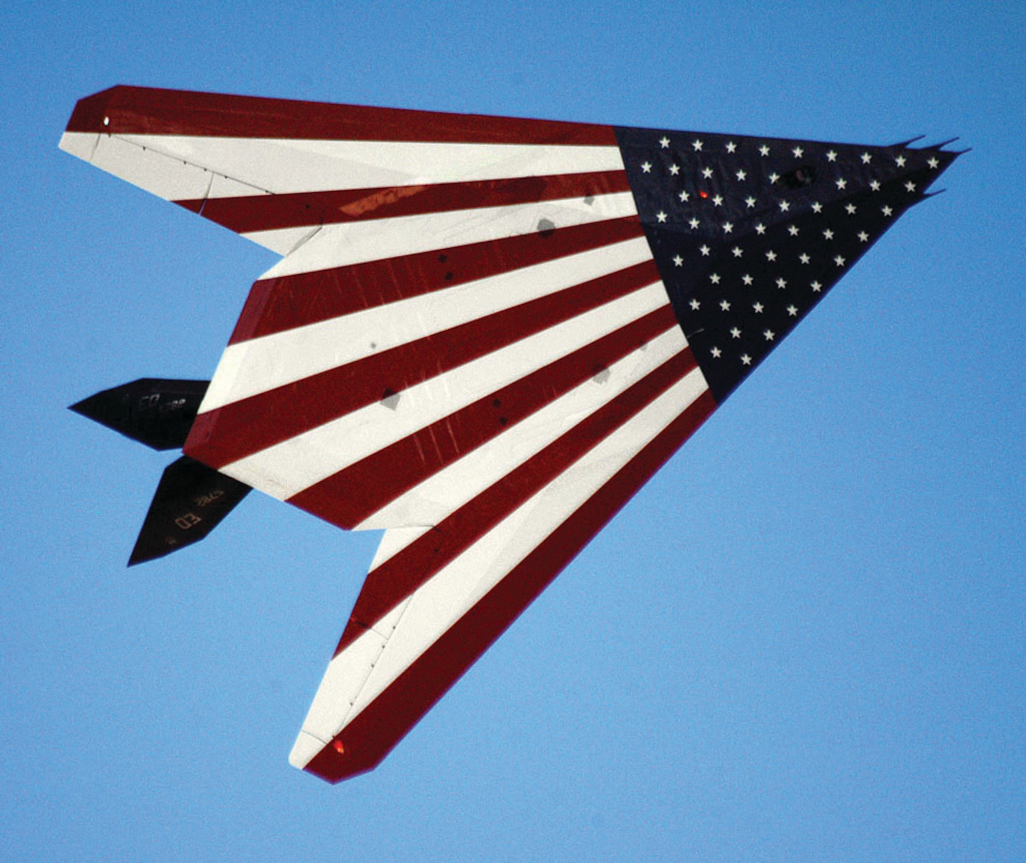EDWARDS AIR FORCE BASE, Calif. -- With the American flag emblazoned on its underbelly, the F-117 Nighthawk with tail number 782 flies past spectators at the 2005 Edwards Open House and Air Show. About 120,000 people attended the event Oct. 22. This stealth fighter, the oldest of five prototypes, was hand made before full production of the aircraft started. (U.S. Air Force photo by Senior Airman Jet Fabara)