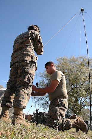 Marines from Marine Expeditionary Unit Service Support Group 24 erect a communications tower on Oct. 25 during a three-day command post exercise. The Marines and sailors of the 24th MEU command element are training to coordinate and operate a forward command operations center.