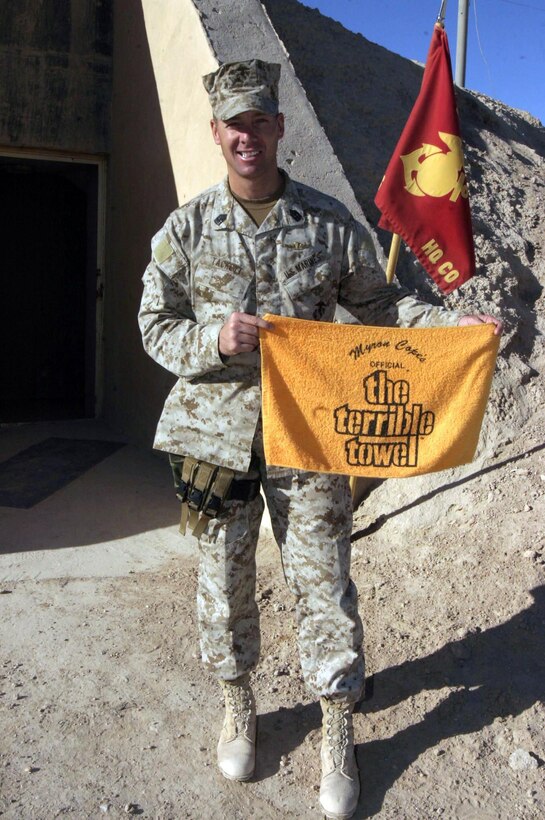 United States Marine Corps 1st Sgt. Timothy C. Tackett, an Upper St. Clair, Pa., native and Steelers fan shows off a Terrible Towel outside of his work space aboard Camp Taqaddum, Iraq. Tackett is the 2nd Force Service Support Group, Headquarters Company, company 1st Sgt and is currently deployed in support of Operation Iraqi Freedom. Tackett's parents, Larry E. and Sharon A. Atkins still reside in Upper St. Clair.