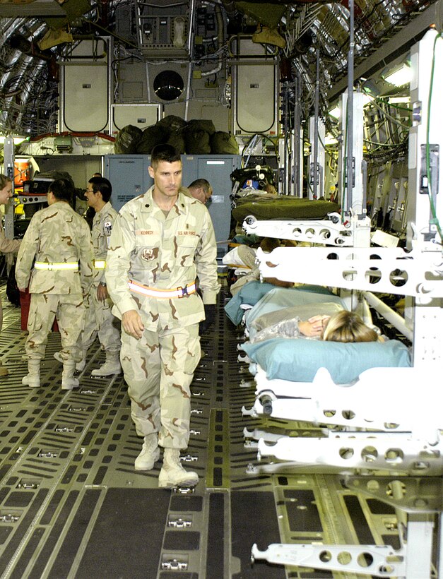 SOUTHWEST ASIA (AFPN) -- Lt. Col. Joe Kennedy checks litter patients before a C-17 Globemaster III medevacs them to Germany. The doctor commands the 386th Contingency Aeromedical Staging Facility at this base. It is one of two staging facilities supporting Operation Iraqi Freedom. (U.S. Air Force photo by Staff Sgt. Scott Campbell)