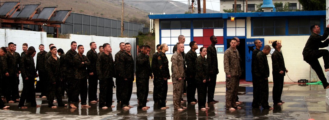 CAMP PENDLETON, Calif. (Oct. 26, 2005) - A row of Marines from the 15th Marine Expeditionary Unit and the 9th Communications Battalion wait to climb the three meter tower during a swim qualification at the 43 Area Swim Tank. (Official USMC photo by Gunnery Sgt. Robert Knoll)