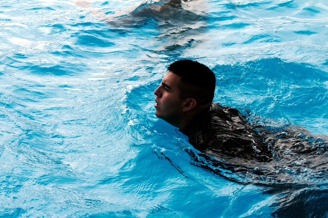 CAMP PENDLETON, Calif. (Oct. 26, 2005) - Corporal Jose Reyna, radio operator with the 15th Marine Expeditionary Unit, swims across the deep end of the pool while completing his fourth class swim qualification. More than 40 Marines from the 15th Marine Expeditionary Unit completed their swim qualifications in preparation for their upcoming deployment next year. (Official USMC photo by Gunnery Sgt. Robert Knoll)
