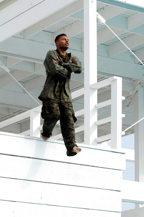 CAMP PENDLETON, Calif. (Oct. 26, 2005) - Corporal Thomas J. Grove, combat cameraman with the 15th Marine Expeditionary Unit, jumps off the three-meter tower while qualifying as a fourth class swimmer. More than 40 Marines from the 15th Marine Expeditionary Unit completed their swim qualifications. (Official USMC photo by Gunnery Sgt. Robert Knoll)