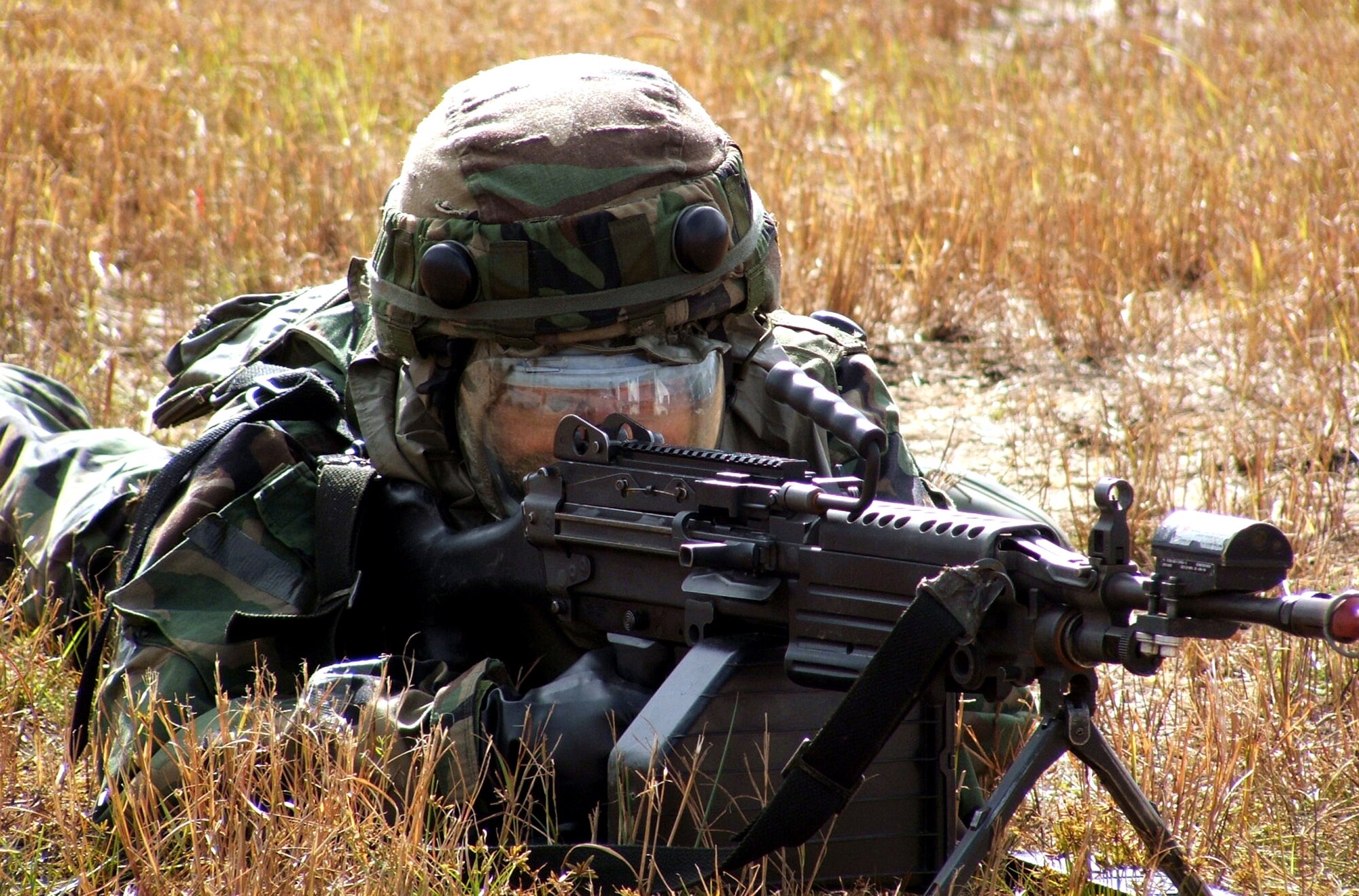 NAVAL AIR ENGINEERING STATION LAKEHURST, N.J. (AFPN) -- An Airman takes up a firing position during a scenario here during exercise Eagle Flag 06-1. The exercise goal is to test the ability of participants to open and establish an air base to an initial-operating capability for a forward operation, regardless of mission or aircraft type. The Airman was there Oct. 26. (U.S. Air Force photo by Tech. Sgt. Scott Sturkol)