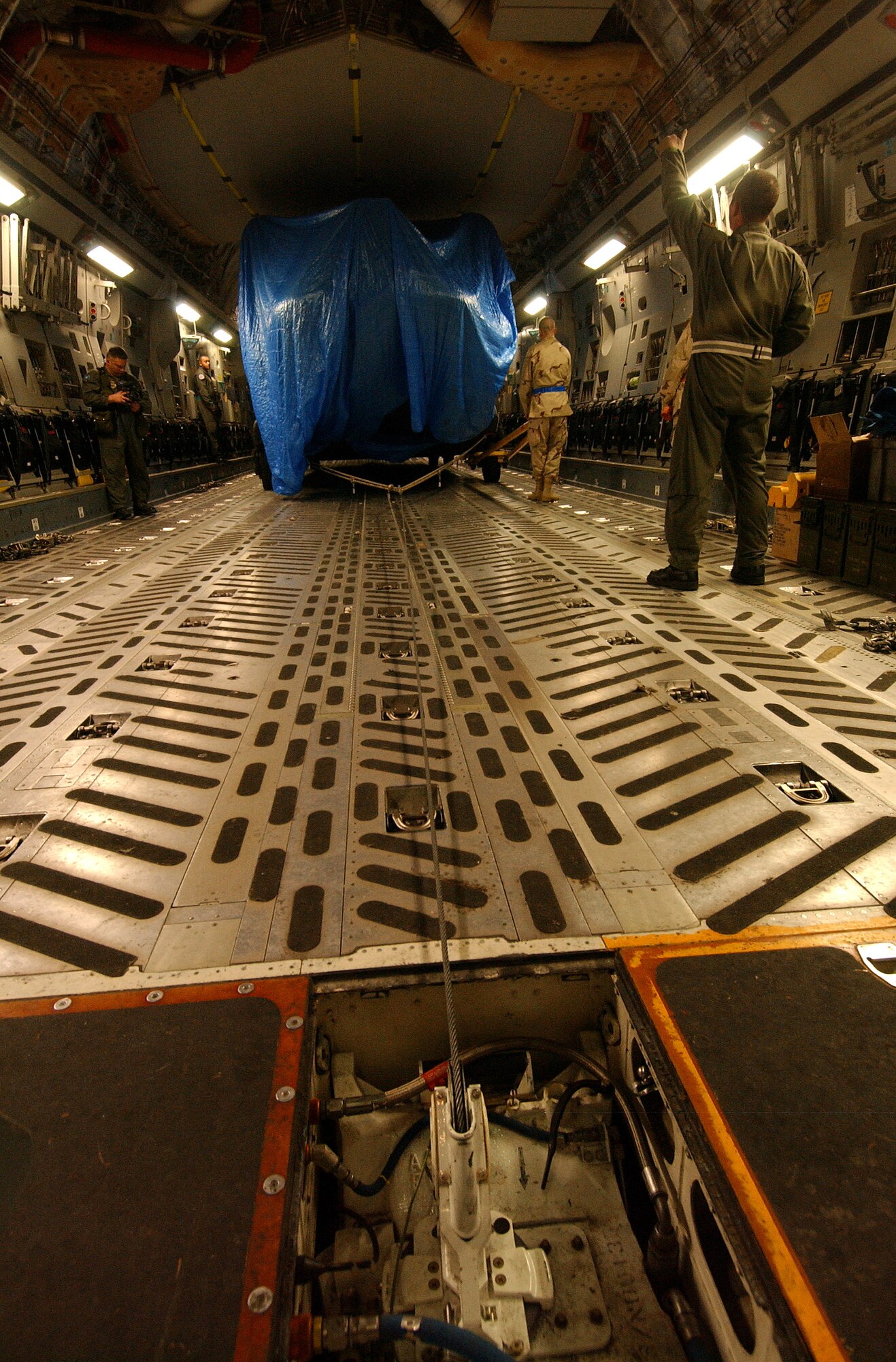 ROTA, Spain (AFPN) -- Airmen load CH-47 Chinook helicopters from Fort Sill, Okla., onto C-17 Globemaster IIIs here. Maintainers will assemble the helicopters at their destination, then flown in humanitarian missions in support of Pakistan earthquake victims. Airmen loaded the helicopters Oct. 24. (U.S. Air Force photo by Staff Sgt. Reynaldo Ramon) 