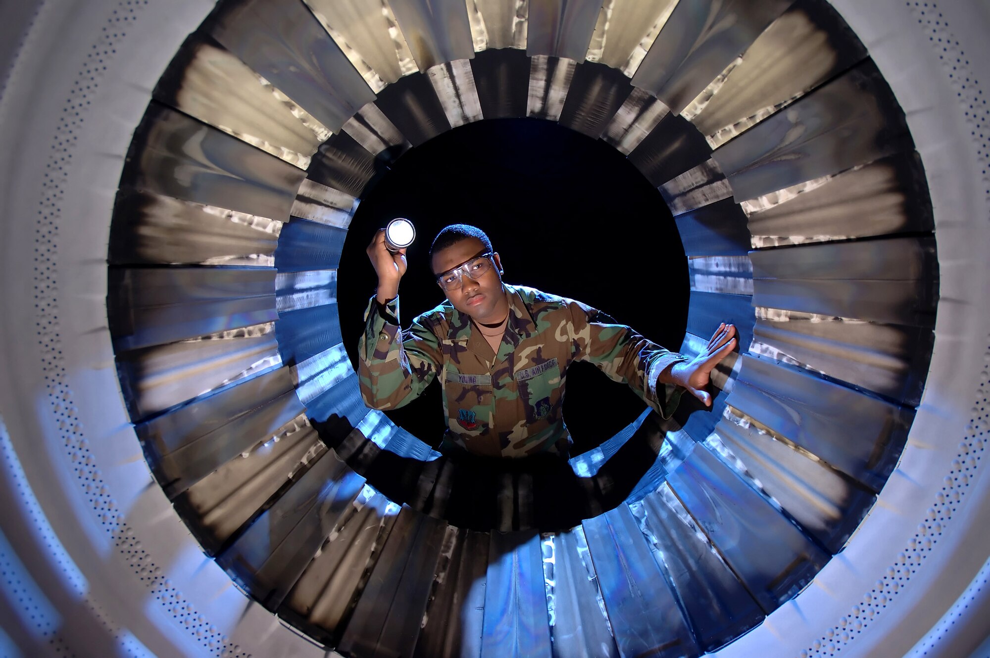 BURLINGTON INTERNATIONAL AIRPORT, Vt. -- Airman 1st Class Jacques Young inspects the "turkey feathers" -- fan blades -- on an F-16 Fighting Falcon's Pratt and Whitney F100-220E engine. The jet engine mechanic works at the propulsion shop of the 158th Fighter Wing here. (U.S. Air Force photo by Master Sgt. Rob Trubia)