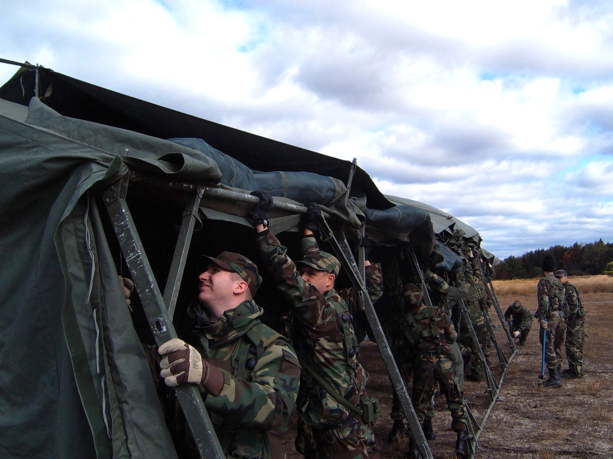 NAVAL AIR ENGINEERING STATION LAKEHURST, N.J. -- Airmen erect a tent here Oct. 23 as part of an Eagle Flag exercise simulating deployment to a bare base environment. (U.S. Air Force photo by Capt. Dave Westover)
