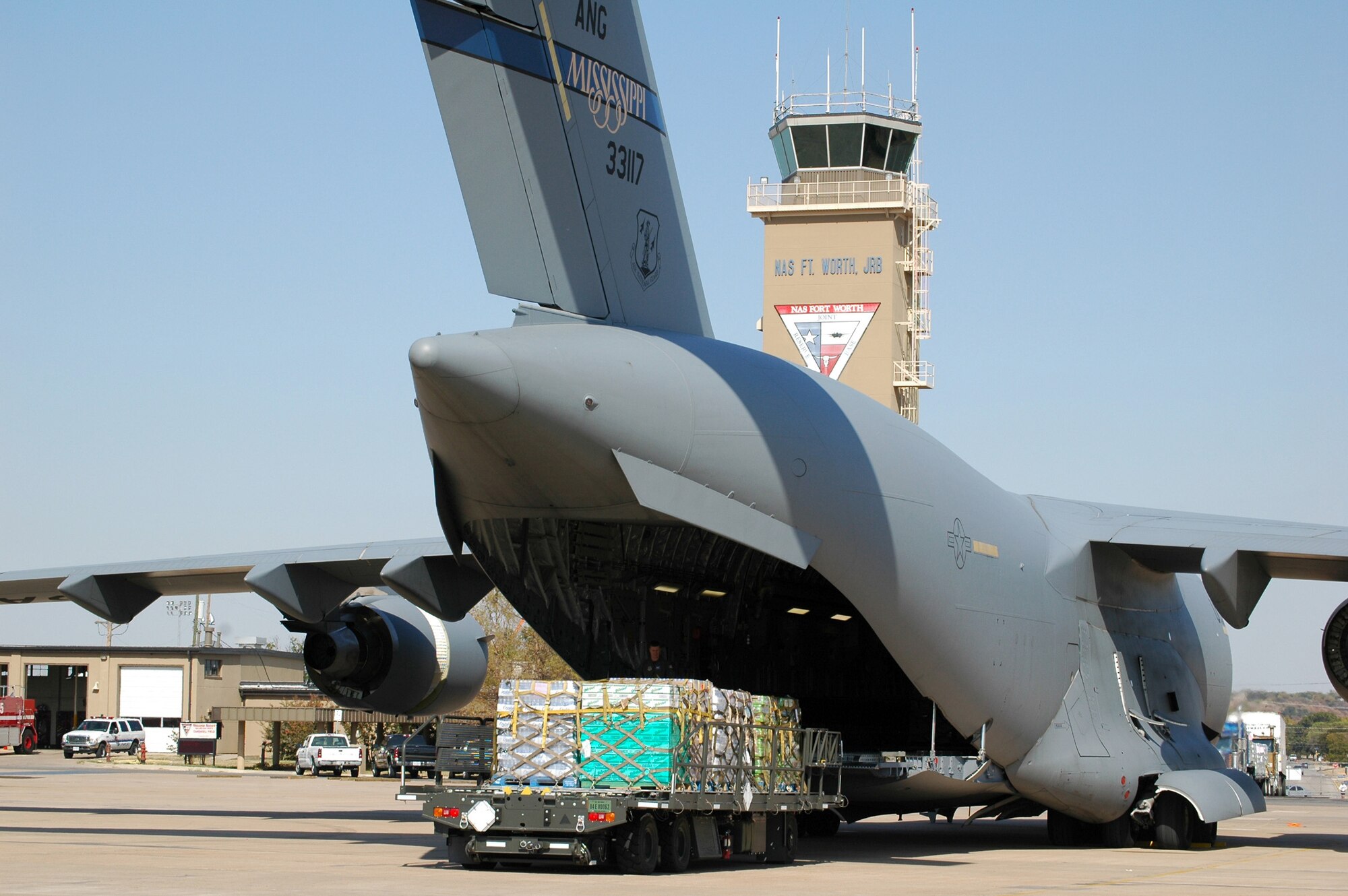 NAVAL AIR STATION - JOINT RESERVE BASE, FORT WORTH, Texas -- Pallets of food and water are loaded onto a C-17 Globemaster III here for delivery to Florida.  As part of a joint effort, Airmen, Sailors and Defense Department civilians assisted the Federal Emergency Management Agency in Hurricane Wilma relief operations Oct. 27.  (U.S. Air Force photo by Senior Master Sgt. Bill L. Goben, Jr.) 