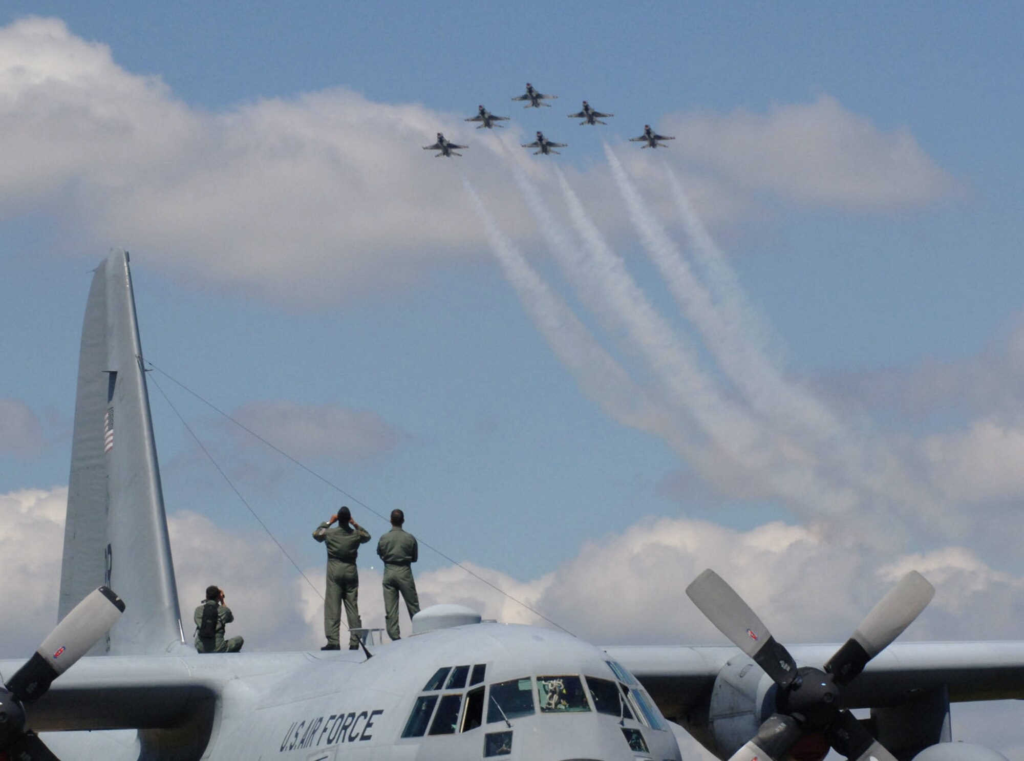 GUATEMALA CITY, Guatemala -- A C-130 Hercules aircrew from the Puerto Rico Air National Guard watch as the Thunderbirds streak by during the Guatemalan International Air Show 2005. The C-130 was part of the U.S Air Force team supporting the show.  (U.S. Air Force photo by Staff Sgt. Matthew Lohr)