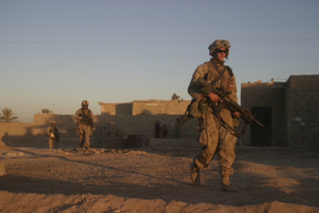 U.S. Marines of 1st Platoon, Company G, 2nd Battalion, 2nd Marines conduct a security patrol in downtown Kharma, Iraq, on Oct. 26, 2005. 