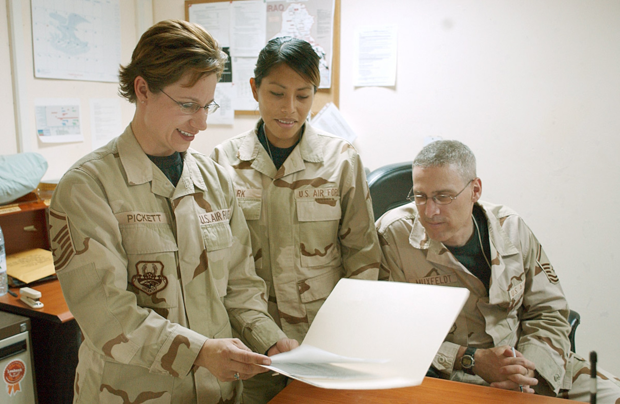 BALAD AIR BASE, Iraq -- Master Sgt. Hayden Pickett (left), 732nd Expeditionary Security Forces Squadron first sergeant, reviews a personnel record with Staff Sgt. Jenna Marks (middle) and Master Sgt. Monte Muxfeldt, both from the 732nd Expeditionary Mission Support Group. (U.S. Air Force photo by Staff Sgt. Tammie Moore)  